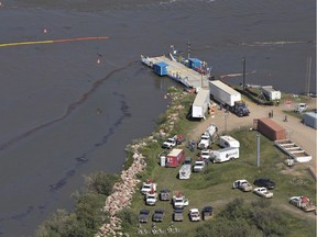 Crews work to clean up an oil spill on the North Saskatchewan river near Maidstone, Sask on Friday July 22, 2016. Husky Energy has said between 200,000 and 250,000 litres of crude oil and other material leaked into the river on Thursday from its pipeline. THE CANADIAN PRESS/Jason Franson ORG XMIT: EDM119