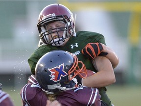 Saskatchewan running back Carmen Agar (1) collides with  New Brunswick linebacker Frederica Jacks (43) during a game at Mosaic Stadium in Regina, Sask. on Thursday July 28, 2016. MICHAEL BELL