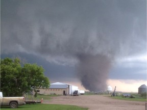 A tornado touches down near Outlook, Sask., on Saturday, July 5, 2014. Residents in parts of Saskatchewan ran for cover, stared in awe or jumped in their trucks to follow what Environment Canada says were several tornadoes that hit Saturday. The agency issued tornado warnings for numerous areas in south-central Saskatchewan Saturday afternoon, and said there were tornadoes reported near Outlook and Kenaston.