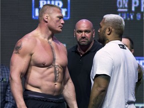 Brock Lesnar, left, looks at Mark Hunt during the UFC 200 weigh-ins in Las Vegas, on July 8, 2016. (L.E. Baskow/Las Vegas Sun via AP)