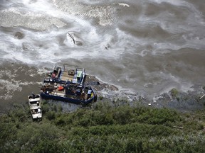 Crews work to clean up an oil spill on the North Saskatchewan river near Maidstone on Friday July 22, 2016. Husky Energy has said between 200,000 and 250,000 litres of crude oil and other material leaked into the river on Thursday from its pipeline.