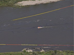 Crews work to clean up an oil spill on the North Saskatchewan river near Maidstone, Sask on Friday July 22, 2016. Husky Energy has said between 200,000 and 250,000 litres of crude oil and other material leaked into the river on Thursday from its pipeline.