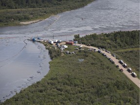 Crews work to clean up the oil spill on the North Saskatchewan River near Maidstone.