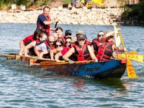 Members of a dragon boat racing team practice on the river in front of Rotary Park in Saskatoon on July 21, 2016.