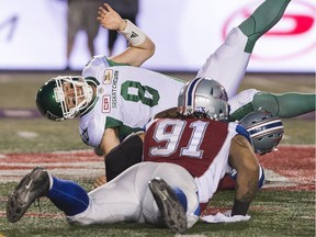 Saskatchewan Roughriders quarterback Mitchell Gale is brought down by the Montreal Alouettes' Alan-Michael Cash during CFL action Friday night.