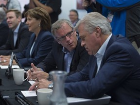 Newfoundland and Labrador Premier Dwight Ball, right, speaks with Saskatchewan Premier Brad Wall at the beginning of a meeting of Premiers in Whitehorse, Yukon, Thursday, July, 21, 2016.