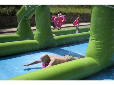 People take part in Slide in the City on Spadina Crescent East at Ravine Drive on Saturday, July 9, 2016. (Liam Richards/Saskatoon StarPhoenix)