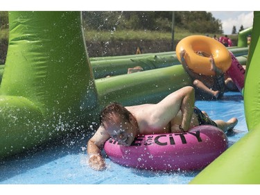 People take part in Slide in the City on Spadina Crescent East at Ravine Drive on Saturday, July 9, 2016. (Liam Richards/Saskatoon StarPhoenix)