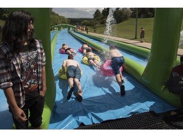 People take part in Slide in the City on Spadina Crescent East at Ravine Drive on Saturday, July 9, 2016. (Liam Richards/Saskatoon StarPhoenix)