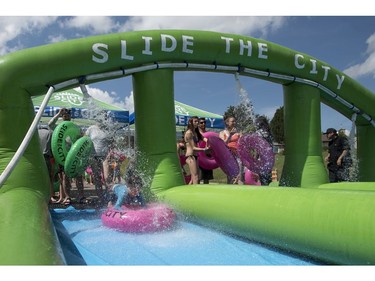 People take part in Slide in the City on Spadina Crescent East at Ravine Drive on Saturday, July 9, 2016. (Liam Richards/Saskatoon StarPhoenix)