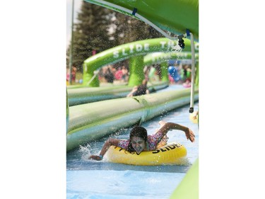 People take part in Slide in the City on Spadina Crescent East at Ravine Drive on Saturday, July 9, 2016. (Liam Richards/Saskatoon StarPhoenix)