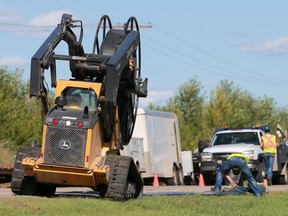 Workers roll out a 30-kilometre waterline that will bring water from the South Saskatchewan River to Prince Albert's water treatment plant on July 25, 2016.