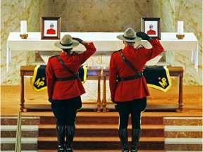 RCMP officers salute at an ecumenical memorial service for constables Robin Cameron and Marc Bourdages at St. Agnes Church in Halifax on Wednesday, July 19, 2006. The officers were shot after chasing an assault suspect in rural Saskatchewan and both died in hospital.
