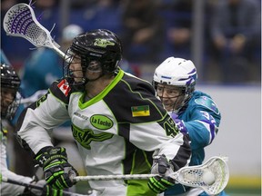 Saskatchewan Rush forward Mark Matthews keeps the ball away from Rochester Knighthawks defense Jon Sullivan in NLL first half on Friday, February 19th, 2016.