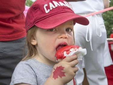 Paraskvya Lacach is dressed appropriately for Canada Day enjoying a Canada Day cupcake at the holiday celebration at Deifenbaker Park in Saskatoon put on by the Optimist Club, July 1, 2016.