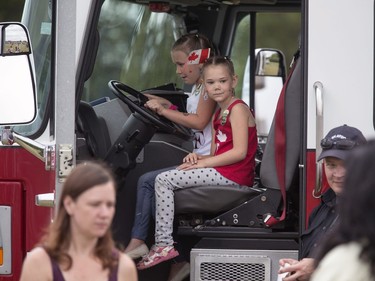 Thousands enjoy the Canada Day festivities and the reaffirmation of their citizenship, cultural entertainment on a stage, Canada Day cupcakes, food trucks, bouncing toys for kids and  displays spread out over Diefenbaker Park in Saskatoon, July 1, 2016.