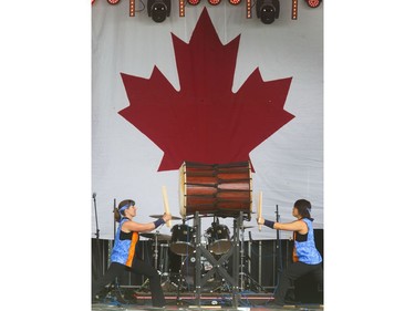 Thousands enjoy the Canada Day festivities and the reaffirmation of their citizenship, cultural entertainment on a stage,  Canada Day cup cakes, food trucks, bouncing toys for kids and  displays spread out over Diefenbaker Park in Saskatoon,  July 1, 2016.