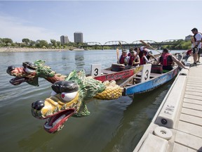 Competitors board their boats prior to racing during the FMG's Dragon Boat Festival fundraising event at Rotary Park, July 25, 2014.