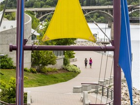 Slightly cooler weather and some clouds on Monday didn't deter these two people from taking a stroll through River Landing, July 4, 2016 (GORD WALDNER/Saskatoon StarPhoenix)