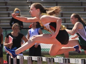 Emily Coghill races for Centennial High School in the 80 meter senior girls hurdles at the high school track meet at Griffith Stadium, May 29, 2014.