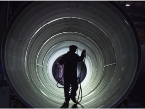 A worker inside a pipe at Mitsubishi Hitachi Power Systems Canada Ltd.'s manufacturing plant in Saskatoon.