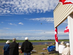 Spectators watch radio-controlled planes take flight during the Richardt Airfield grand opening on Valley View Road, Saskatchewan on Saturday, July 2nd, 2016.