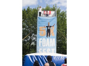 Cindy Drummond jumps off a platform during post-race celebrations after the 5K Foam Fest run near Pike Lake on Saturday, July 2nd, 2016.