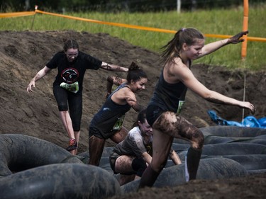 Competitors run through an obstacle while attempting to complete the 5K Foam Fest run near Pike Lake, July 2, 2016.