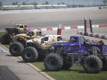 Monster trucks are lined up before the main event at the Monster and Mayhem show at the Wyant Group Raceway in Saskatoon, Saskatchewan on Saturday, July 16th, 2016.