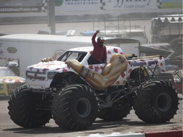 The driver in the "Tough Guy" monster truck celebrates to the crowd during the Monster and Mayhem show at the Wyant Group Raceway in Saskatoon, Saskatchewan on Saturday, July 16th, 2016.