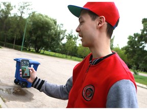 Jordan Wong finds a Pokemon on his phone near his home in Saskatoon on July 11, 2016.