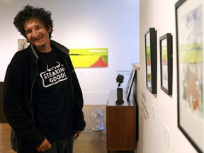 Donald Bird with his paintings and drawings hanging in the Art Placement gallery in Saskatoon on July 26, 2016. (Michelle Berg / The StarPhoenix)