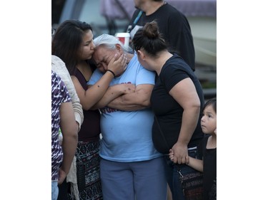 Family and friends are overcome with emotion as they attend a candlelight vigil on Waterloo Crescent in Saskatoon for six-week-old Nikosis Jace Cantre, July 5, 2016. A 16-year-old young offender has been charged with second-degree murder in the death.