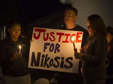 People attend a candlelight vigil on Waterloo Crescent in Saskatoon for six-week-old Nikosis Jace Cantre, July 5, 2016. A 16-year-old girl has been charged with second-degree murder in the death.