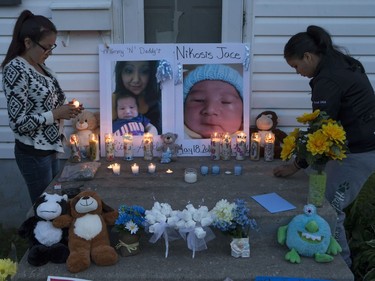 People attend a candlelight vigil on Waterloo Crescent in Saskatoon for six-week-old Nikosis Jace Cantre, July 5, 2016. A 16-year-old young offender has been charged with second-degree murder in the death.