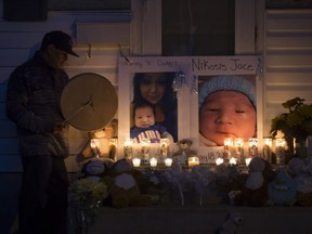 People attend a candlelight vigil on Waterloo Crescent in Saskatoon for six-week-old Nikosis Jace Cantre, July 5, 2016. A 16-year-old young offender has been charged with second-degree murder in the death.