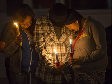 Family members, including mother Alyssa Bird (R), attend a candlelight vigil on Waterloo Crescent in Saskatoon for six-week-old Nikosis Jace Cantre, July 5, 2016. A 16-year-old young offender has been charged with second-degree murder in the death.