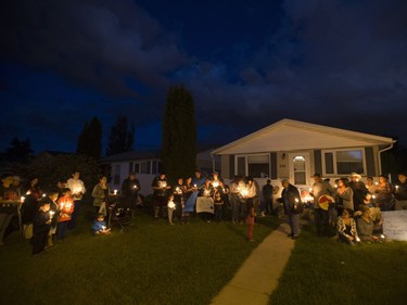 People attend a candlelight vigil on Waterloo Crescent in Saskatoon for six-week-old Nikosis Jace Cantre, July 5, 2016. A 16-year-old young offender has been charged with second-degree murder in the death.