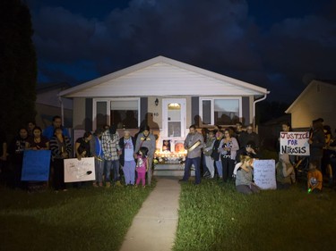 People attend a candlelight vigil on Waterloo Crescent in Saskatoon for six-week-old Nikosis Jace Cantre, July 5, 2016. A 16-year-old young offender has been charged with second-degree murder in the death.