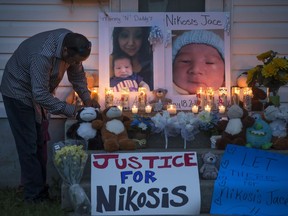 People attend a candlelight vigil on Waterloo Crescent in Saskatoon for six-week-old Nikosis Jace Cantre on July 5, 2016.