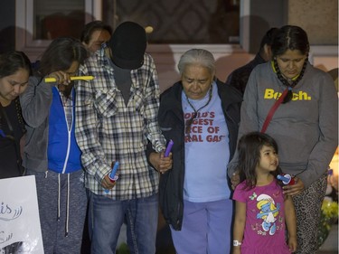 Family members, including mother Alyssa Bird(R), attend a candlelight vigil on Waterloo Crescent in Saskatoon for six-week-old Nikosis Jace Cantre, July 5, 2016. A 16-year-old young offender has been charged with second-degree murder in the death.