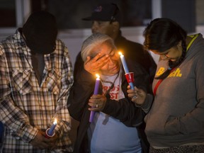 Family members, including mother Alyssa Bird (R), attend a candlelight vigil on Waterloo Crescent in Saskatoon for six-week-old Nikosis Jace Cantre, July 5, 2016. A 16-year-old young offender has been charged with second-degree murder in the death.