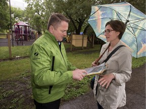 Robin Hansen, right, collected over 800 signatures from an online petition to save the old Kinsmen Park playground and presented it councillor Darren Hill, Monday, July 11, 2016.