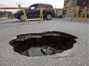 Barricades and restricted traffic lanes around a sinkhole at Third Avenue and 20th Street East, July 13, 2016.