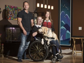 Jason Stanoffsky, centre,, pictured with his service dog Harlem, his best friend Quinten Chaban and his caregiver Margie Rivera, is fundraising to retrofit his northern resort to be fully accessible to wheelchair users.