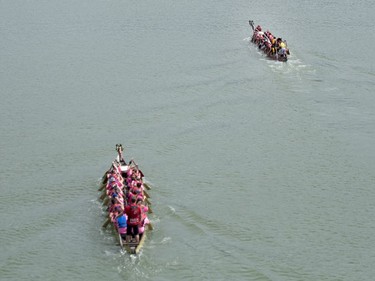 Competitors paddle their dragon boats in a race during FMG's Saskatoon Dragon Boat Festival along the South Saskatchewan river near Rotary Park in Saskatoon, July 23, 2016.