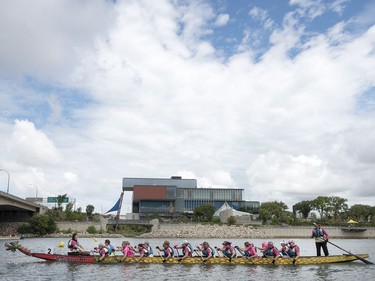 Competitors paddle their dragon boat to the starting line during FMG's Saskatoon Dragon Boat Festival along the South Saskatchewan river near Rotary Park in Saskatoon, July 23, 2016.