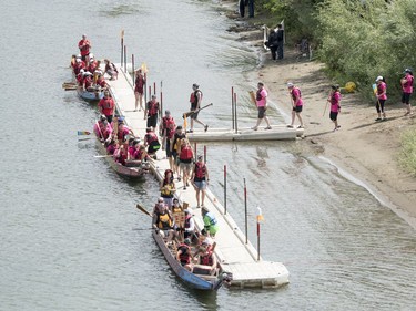 Competitors board their dragon boats during FMG's Saskatoon Dragon Boat Festival along the South Saskatchewan river near Rotary Park in Saskatoon, July 23, 2016.