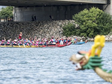 Competitors paddle their dragon boats in a race during FMG's Saskatoon Dragon Boat Festival along the South Saskatchewan river near Rotary Park in Saskatoon, July 23, 2016.