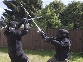 Kelly Bjorndalen, right, and Lindsay Goodwin of the Saskatoon Historical Fencing Society demonstrate the sport, Thursday, July 28, 2016.